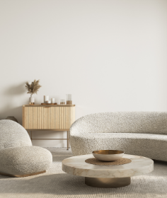 Moderne Wohnzimmermöbel in Grau und Beige, mit einem runden Tisch, einer gemütlichen Couch und stimmungsvollem Licht.