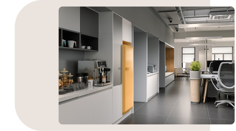 Moderne Büroküche mit grauen und weißen Schränken und einer gelben Akzenttür. Auf der Arbeitsfläche stehen eine Kaffeemaschine und verschiedene Snacks, die den Mitarbeitern zur Verfügung stehen. Im Hintergrund ist ein offener Bürobereich mit Schreibtischen und Stühlen zu sehen. Die Küche verbindet sich nahtlos mit dem Arbeitsbereich und bietet eine funktionale und einladende Atmosphäre.