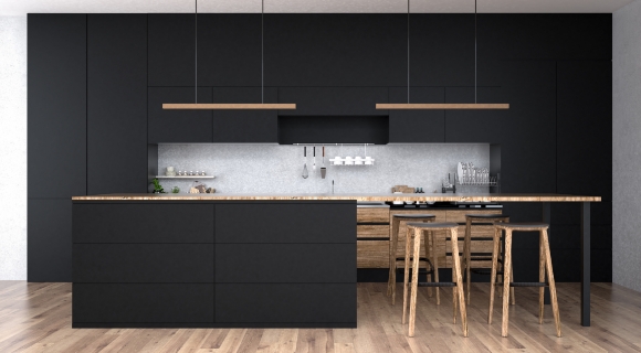Geschlossene mattschwarze Designk&uuml;che mit Holzdetails, Pendelleuchten und Barhockern
