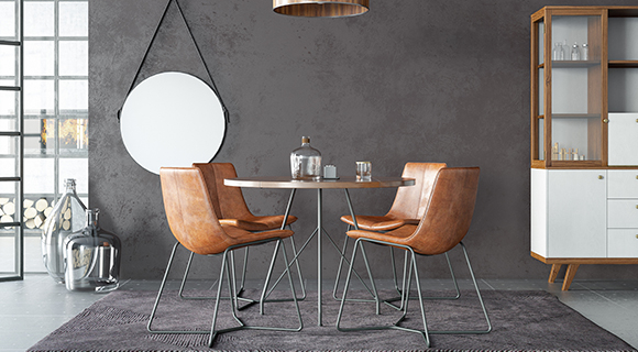 Essbereich mit rundem Tisch und vier braunen Lederstühlen mit Metallgestell auf einem grauen Teppich.
