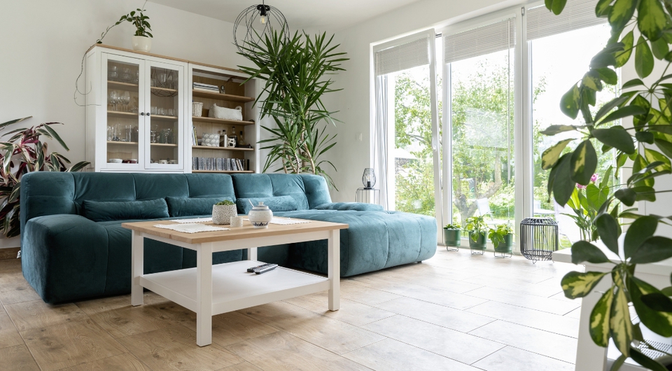 Blau-grünes Sofa in L-Form mit Schlaffunktion